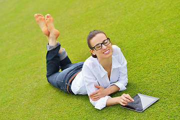 Image showing Beautiful young woman with  tablet in park