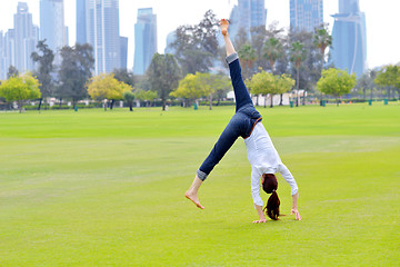 Image showing young woman jumping in park