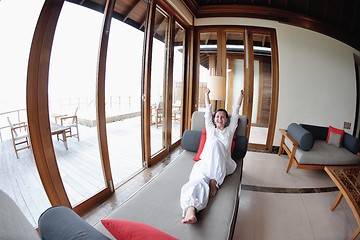 Image showing happy young woman relax at home on sofa