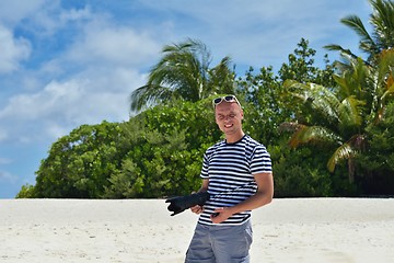 Image showing photographer taking photo on beach