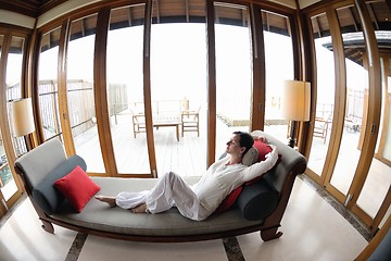 Image showing happy young woman relax at home on sofa