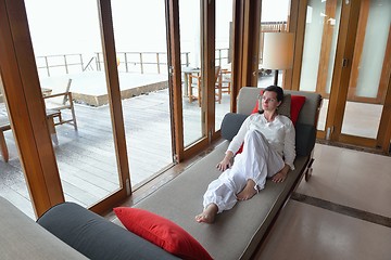 Image showing happy young woman relax at home on sofa