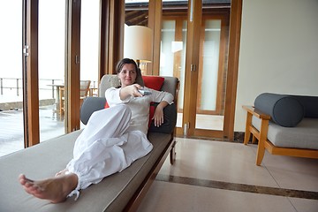 Image showing happy young woman relax at home on sofa