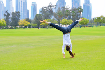 Image showing young woman jumping in park