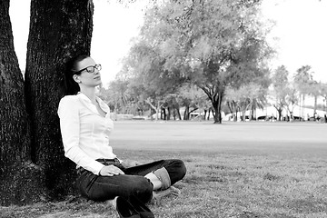 Image showing Beautiful young woman with  tablet in park