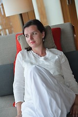 Image showing happy young woman relax at home on sofa