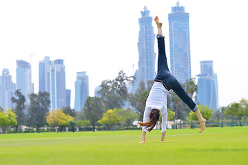 Image showing young woman jumping in park