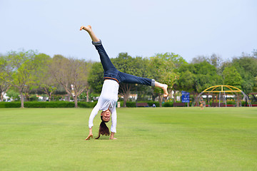 Image showing young woman jumping in park