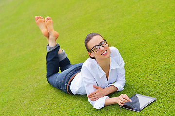 Image showing Beautiful young woman with  tablet in park