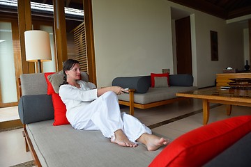 Image showing happy young woman relax at home on sofa