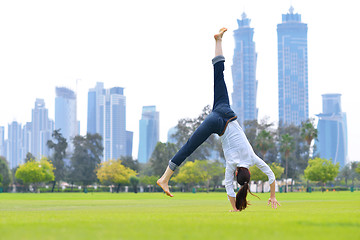 Image showing young woman jumping in park