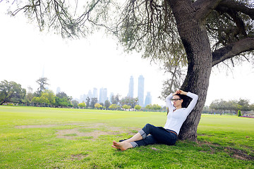 Image showing Beautiful young woman with  tablet in park