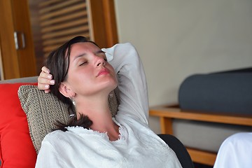 Image showing happy young woman relax at home on sofa