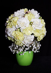 Image showing round festive bouquet of yellow carnations