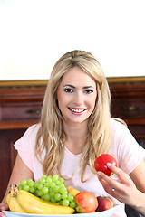 Image showing Smiling young woman with a bowl of fruit