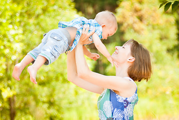 Image showing Mom and son playing outdoor together