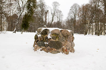 Image showing ancient pagan stone altar eternal fire snow winter 