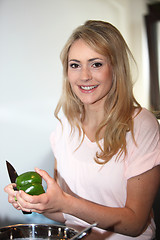 Image showing Beautiful woman cutting a bell pepper