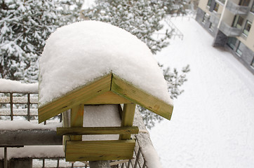 Image showing snow covered roof nesting-box on the balcony edge  