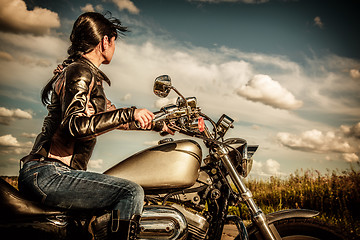 Image showing Biker girl on a motorcycle