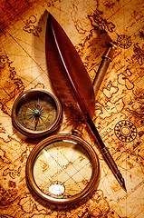 Image showing Vintage magnifying glass lies on an ancient world map