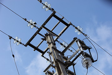 Image showing Overhead electricity pole against a blue sky