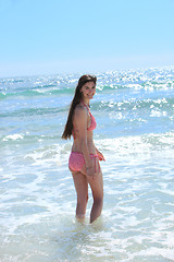 Image showing Beautiful woman in a bikini entering the sea