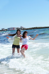 Image showing Two women frolicking in the sea