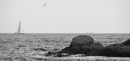 Image showing sea, rocks, and a sailboat