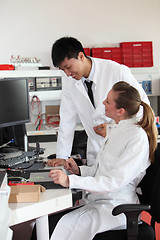 Image showing Two lab technicians discussing their work
