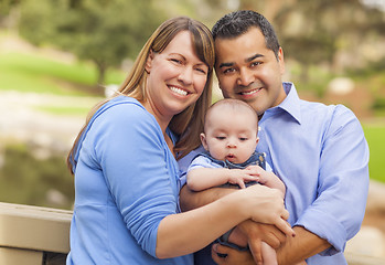 Image showing Happy Mixed Race Family Posing for A Portrait Outside