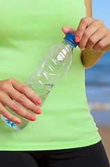 Image showing Woman Holding Bottle of Water