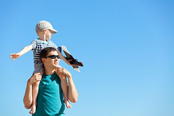 Image showing family playing a toy plane