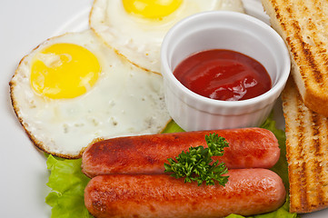 Image showing Fried eggs with sausages