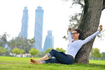 Image showing Beautiful young woman with  tablet in park