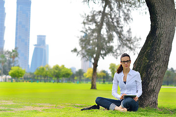 Image showing Beautiful young woman with  tablet in park