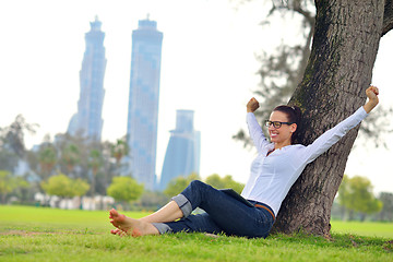 Image showing Beautiful young woman with  tablet in park