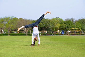 Image showing young woman jumping in park