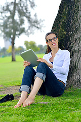 Image showing Beautiful young woman with  tablet in park