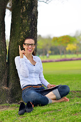 Image showing Beautiful young woman with  tablet in park