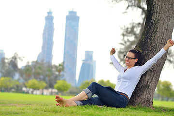 Image showing Beautiful young woman with  tablet in park