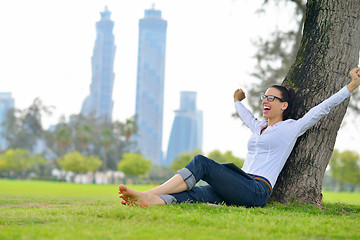 Image showing Beautiful young woman with  tablet in park