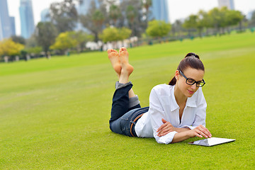 Image showing Beautiful young woman with  tablet in park