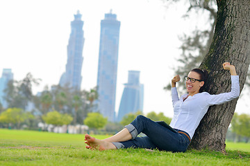 Image showing Beautiful young woman with  tablet in park