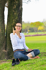 Image showing Beautiful young woman with  tablet in park