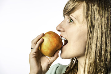 Image showing Young girl biting into apple