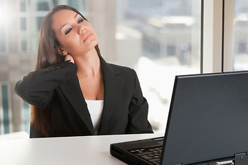 Image showing Businesswoman Sitting at Her Desk Tired