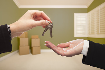 Image showing Woman Handing Over the House Keys Inside Empty Green Room