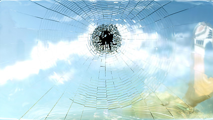 Image showing Broken window glass and blue sky isolated 