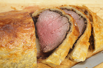 Image showing Beef Wellington slices on a board